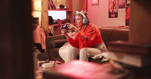Gamer, stress and lose with competition, esports and frustrated or mistake. Woman, rage and technology with neon, lounge and apartment or home living room with console and fail for video game play