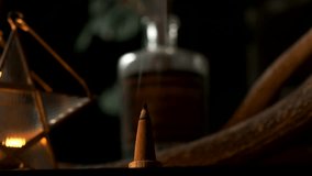 Detail view of a incense cone burning with smoke in a dark esoteric setting, in slow motion - Powered by Shutterstock - Get 15% off with code: PIKWIZARD15