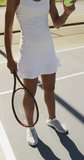 Vertical video of african american female tennis player with ball and tennis racket. female tennis, sport and competition.