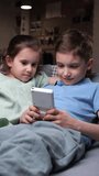 vertical video children play old vintage handheld game console. Popular game. 