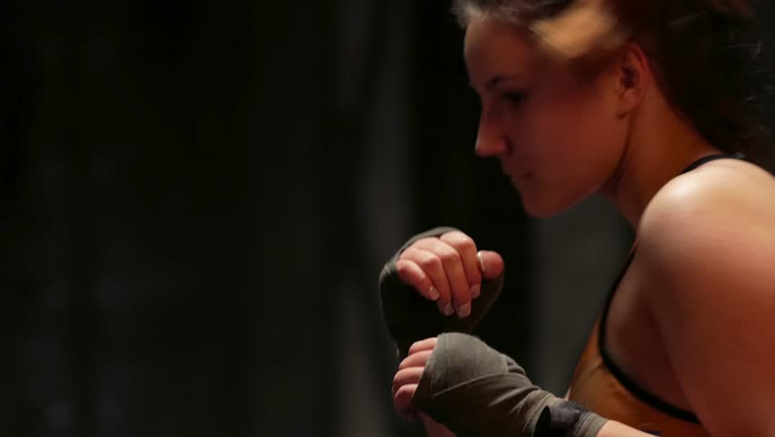 Young woman boxer making punches with hands in protective bandage on training | Shutterstock HD Video #34756177