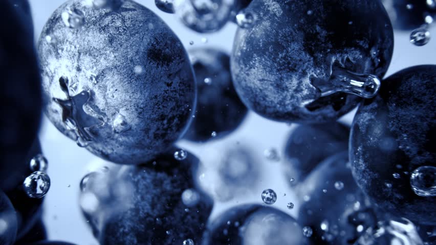 Super Slow Motion Shot of Fresh Blueberries Falling into Water and Creating Bubbles at 1000fps.