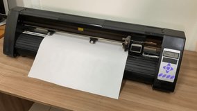 paper plotter. flatbed plotter. The device is on the table. Slow motion video. High-quality shooting in 4K format.