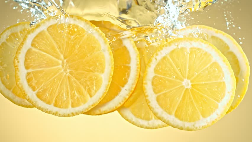 Super Slow Motion Shot of Fresh Lemon Slices Falling and Flowing in Water at 1000 fps.