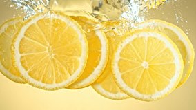 Super Slow Motion Shot of Fresh Lemon Slices Falling and Flowing in Water at 1000 fps. - Powered by Shutterstock - Get 15% off with code: PIKWIZARD15