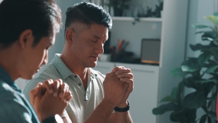 Top view of skilled diverse prayer clasping hand and praying to god while sitting at chair in circle. Top down aerial view of people folded hand while sitting with opened bible on laps. Symposium. Royalty-Free Stock Footage #3475808125