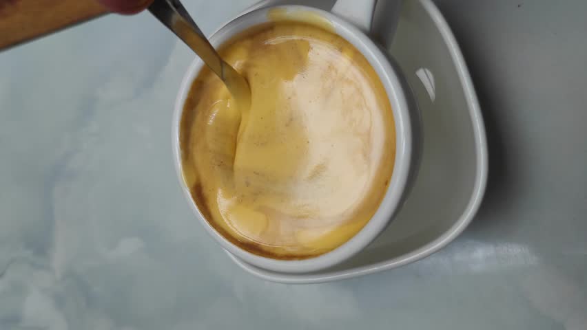 Vietnamese Egg Coffee on white cup - Famous drink in Hanoi Vietnam - or Call ca phe trung is made by beating an egg yolk with sweetened condensed milk 