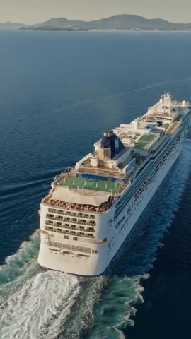 Flying over cruise ship in the sea. Huge cruise ship with football field and swimming pools. Vertical Screen Royalty-Free Stock Footage #3475836203