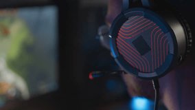 Gamer in headset plays video game PC Computer club Real-time strategy multiplayer online competition. Esports tournament skill. Professional cyber sport championship. Modern gaming equipment earphones