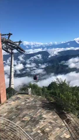 Hills seen with large amount clouds  beautiful place with cabelcar