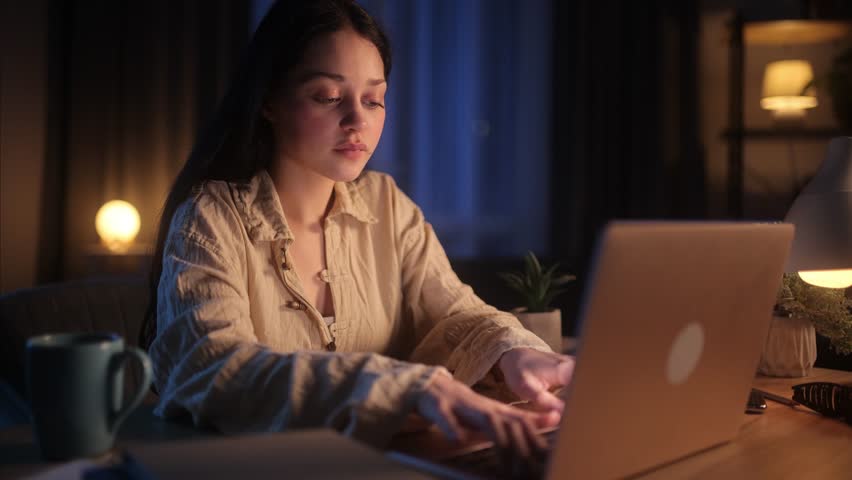 A Young, Beautiful Woman is Surprised by the High-Speed Internet, a Stream of Wind and Energy Breaks out of the Laptop Monitor and Blows her Hair. Amazed and Satisfied by the Good News Royalty-Free Stock Footage #3476037923