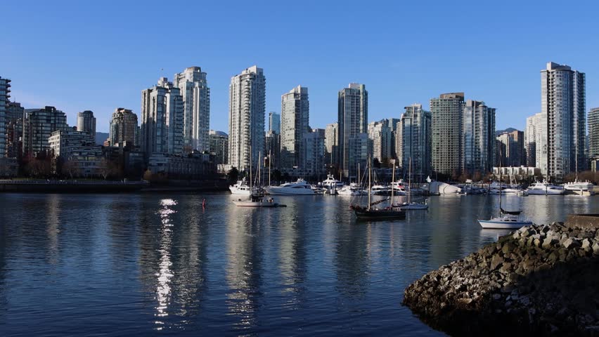 False Creek Seawall views in Vancouver, British Columbia, Canada. Downtown Vancouver Skyline. 4k video