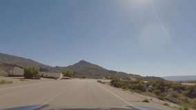 First person view, FPV, from dashcam of car driving towards abandoned diner in Tabernas desert, Almeria, Andalusia, Spain, Europe. Road trip video in POV in arid, dry climate