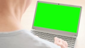 Over shoulder view elderly man hesitantly uses laptop, green screen mockup, representing challenges and opportunities digital literacy for seniors, Technology and Aging, Learning New Skills