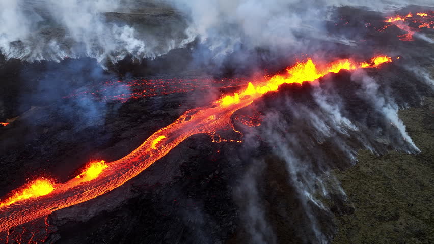 Volcano eruption, red hot burning lava erupting close up, drone fly over crater in Iceland