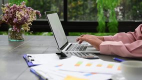 Muslim woman wear hijab work from home office typing laptop keyboard on wooden desk with office supply happy smiling face. Young Asian arabian muslim women working summary report business graph chart - Powered by Shutterstock - Get 15% off with code: PIKWIZARD15
