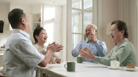 group of happy senior asian people two couples sitting at table at home enjoying a pleasant conversation - Powered by Shutterstock - Get 15% off with code: PIKWIZARD15