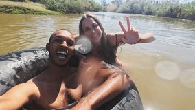 Selfie, swimming and couple in lake in nature live streaming on holiday, vacation and weekend. Peace sign, camping and man and woman on fun adventure for content creation, vlog and travel influencer - Powered by Shutterstock - Get 15% off with code: PIKWIZARD15