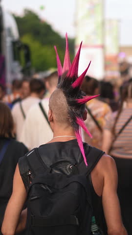 Cool punk rocker dyed mohawk hairstyle. Dressed up hipster enjoy hard rock music fest. Fun male carnival retro hair style. Fan stylish haircut. Queer lgbt pride party. Joyful gay person walk csd day.