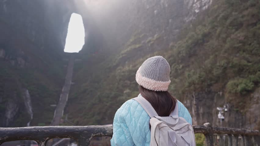 Young female tourist taking a photo of the The Heaven