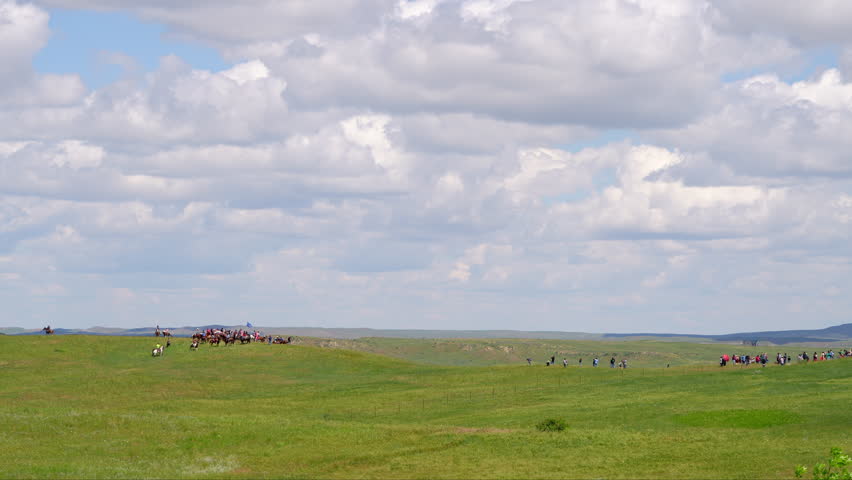 Re-enactors on horseback in distance