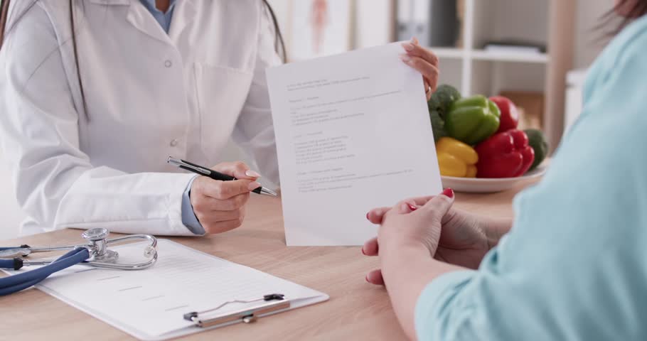 Nutritionist dietician, nutrition specialist consulting patient, analyzing food content, developing diet. Giving advice, clinic visit to provide medical counseling, nutritional information, meal plan 