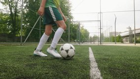 The young footballer is training on the football field. The player is practicing ball control and dribbling. Close-up of the feet with the ball. - Powered by Shutterstock - Get 15% off with code: PIKWIZARD15