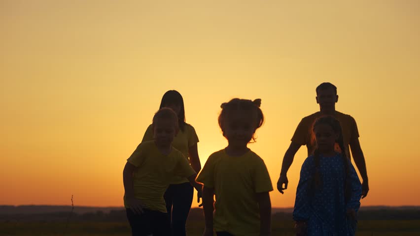 happy family in the park. group of children running silhouette and parents in nature in the park at sunset. happy sun family kid dream concept. friendly family runs silhouette in the park lifestyle Royalty-Free Stock Footage #3476476315