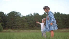 children brother sister in park. small children and baby walk in the park in nature holding hands. happy family kid dream concept. family small children walking on the grass sun in summer in park - Powered by Shutterstock - Get 15% off with code: PIKWIZARD15