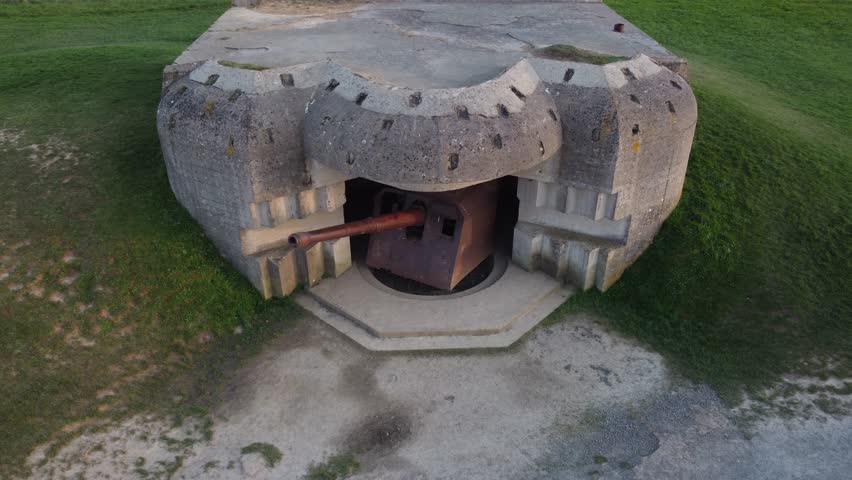 WW2 History, Atlantic wall cannon battery over the coast of Normandy, France (Gold and Juno beaches) - Aerial view D-Day.