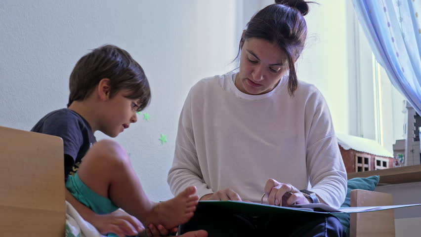 Mother And Son Engage In School Homework - Parental Support In Child’s Education Royalty-Free Stock Footage #3476493547