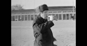 Man drinking beer from bottle on city street, closeup. Alcoholism in public outdoors. Alcohol addiction. Lonely adult person in winter. Lifestyle leisure. Vintage black white film. Retro archive 1980s