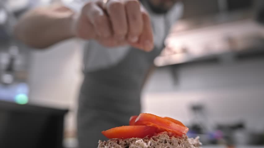 Male head chef prepare tasty fresh bruschetta dish close up. Man cook meal restaurant kitchen. Young adult person work cafe cuisine. Guy make diet lunch food. Culinary worker job. Cookery staff recipe Royalty-Free Stock Footage #3476574513