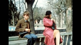 Angry mother scolding adult son on city street. Strict parent raising child in park. Offended teenage boy. Family scolding. Sad person. Archival vintage color film. Old retro archive. 1980s Crimea