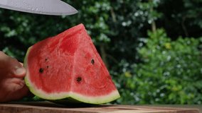 4K slow motion video of cutting a watermelon.