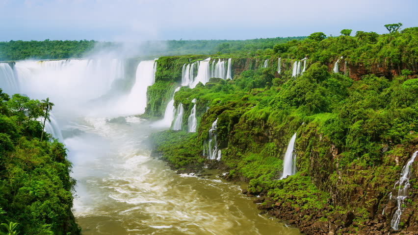 Timelapse of Waterfalls of Iguazu around a big green area and a river, in a sunny day, Foz do Iguacu, Parana, Brazil Royalty-Free Stock Footage #3476663839