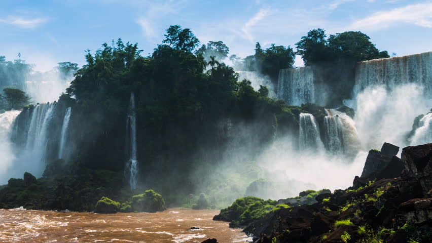 Timelapse of Waterfalls of Iguazu, view from the bottom, around a big green area, in a sunny day, Foz do Iguacu, Parana, Brazil Royalty-Free Stock Footage #3476671423