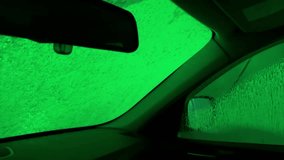A car window is covered in green spots. The spots are glowing and appear to be stars. The car is parked in a parking lot - Powered by Shutterstock - Get 15% off with code: PIKWIZARD15