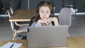 A schoolgirl has an emotional discussion during an online lesson. Distance learning.