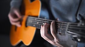 Guitar player plays random chords on the acoustic western guitar with steel strings ,exercises and arpeggios, video with sound, plaing the guitar, muscial instrument