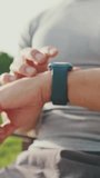 Vertical video, Close-up of unrecognizable young man's hands using smart watch