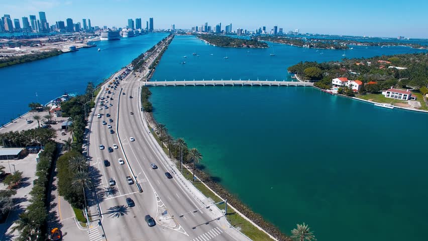 Miami, Florida. Aerial view of MacArthur Causeway and surrounding skyline from drone on a sunny day, slow motion. Royalty-Free Stock Footage #3476850515