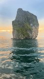 Koh Rok Island Exploring thai beach travelling on a long tail boat on the calm ocean travel vertical with beautiful rock formation ha long bay sunset golden hour  