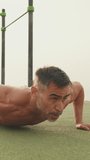 Vertical video, Middle aged muscular man doing push up exercises outdoors