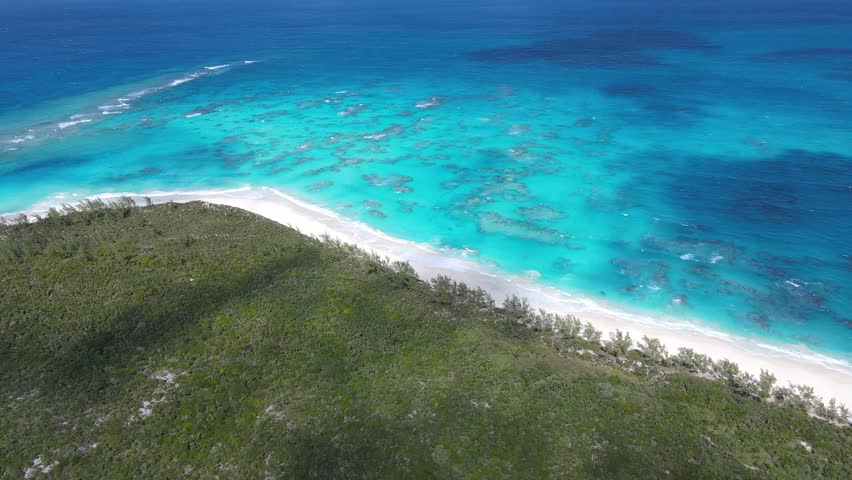 Beautiful cinematic aerial view of the Bahamas island - turquoise oceans, water sports sailing, beach walks, water bikes 