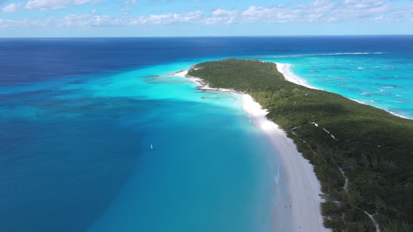 Beautiful cinematic aerial view of the Bahamas island - turquoise oceans, water sports sailing, beach walks, water bikes 