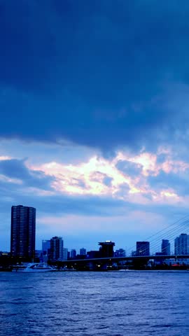 Erasmus Bridge (Erasmusbrug) and Rotterdam skyline illuminated at night. Rotterdam, Netherlands. Camera pan