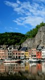 Picturesque view of Dinant town, Dinant Citadel and Collegiate Church of Notre Dame de Dinant over River Meuse. Belgium. Camera pan