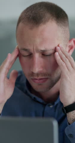 Man, headache and burnout at office with laptop, software glitch or website 404, stress and massage temple for relief. Migraine, pain and fatigue with technology error, brain fog and overworked