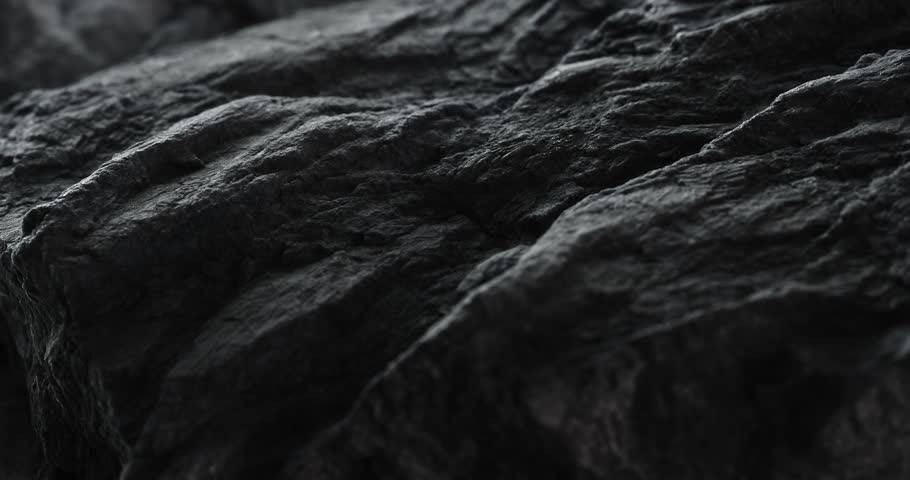 Oil Streaks Across Jagged Rock Texture. Close-up, shallow dof.